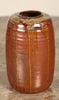 A studio pottery vase with khaki glaze and drip overglaze