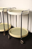A pair of midcentury plastic bedside tables/drinks trolley with metal castors