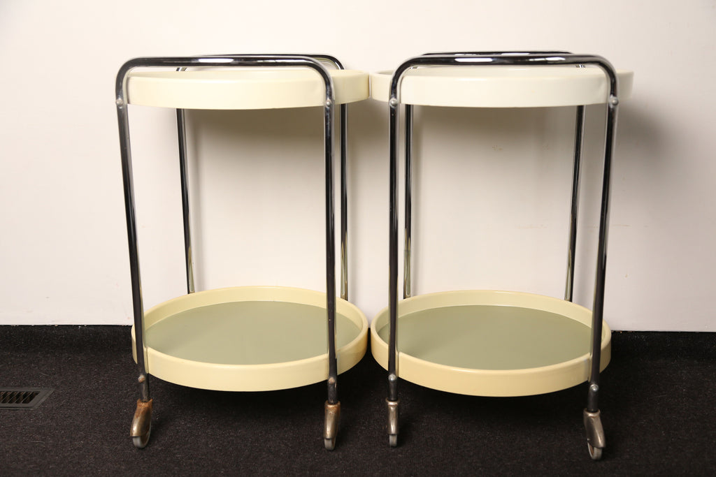 A pair of midcentury plastic bedside tables/drinks trolley with metal castors